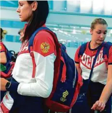  ?? AFP ?? Russian athletes wait to check in before their team’s departure to the Rio Games.