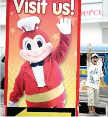  ??  ?? A POSTER featuring Jollibee’s mascot is seen on a street in Manila in this June 22, 2011 photo.