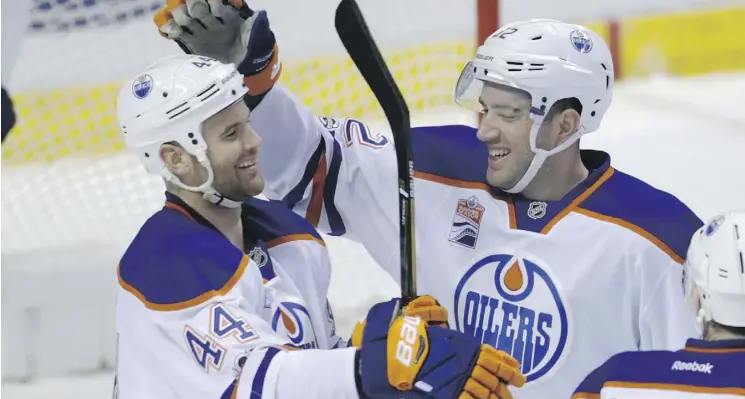  ?? LYNNE SLADKY/THE ASSOCIATED PRESS ?? Edmonton Oilers defenceman Eric Gryba, right, celebrates a goal with winger Zack Kassian after Kassian’s second-period goal against the Florida Panthers in Sunrise, Fla. The Oilers grabbed a 4-3 victory despite losing Andrej Sekera during the game.