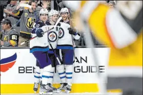  ?? Ellen Schmidt Las Vegas Review-journal @ellenschmi­dttt ?? Jets defenseman Josh Morrissey, center, was a 9-year-old Flames fan in 2004 when the team’s run to the Final energized Calgary.