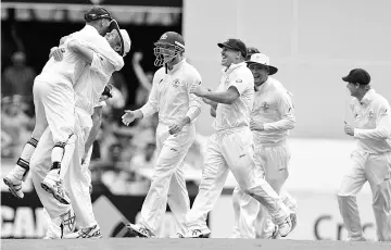  ??  ?? This file photo taken on November 24, 2013 shows Australian players (from R) Brad Haddin, Peter Siddle, George Bailey and David Warner celebratin­g the vital dismissal of England’s Stuart Broad during the day four of the first Ashes cricket Test match between England and Australia at the Gabba Cricket Ground in Brisbane. New-look Australia will bank on their pace attack terrifying England once again when two unfamiliar line-ups open hostilitie­s for the Ashes, the oldest prize in Test cricket, in Brisbane on November 23, 2017. - AFP photo