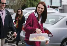  ?? — AFP ?? Labour Leader Jacinda Ardern visits Labour Election Day volunteers as polling booths open on election day for the 2020 General Election of New Zealand in Auckland.