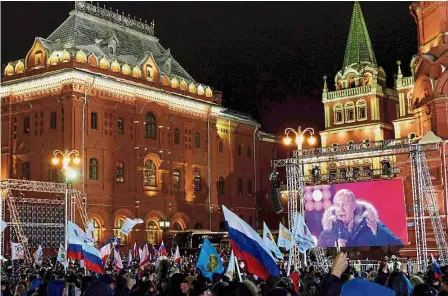  ??  ?? Rapt audience: A large crowd listening to a speech by Putin during a rally at Manezhnaya Square in Moscow. — AFP