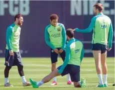  ?? — AFP ?? Barcelona’s Lionel Messi (left) chats with Neymar (second left) and Gerard Pique (right) during a training session at the Sports Center FC Barcelona Joan Gamper in Sant Joan Despi, near Barcelona on Saturday.