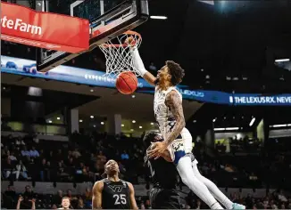  ?? ELDON LINDSAY/GEORGIA TECH ATHLETICS ?? Georgia Tech forward Ja’von Franklin dunks over Virginia Tech forward Justyn Mutts during a 77-70 win on Feb. 15 at Mccamish Pavilion. Tech has won five of its past seven games.