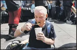  ?? Genaro Molina Los Angeles Times ?? A HOMELESS MAN eats soup prepared by Chef Lovejoy Cole during the weekly food giveaway by My Friend’s House Foundation on skid row.