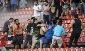  ?? ?? Fans clash on the terraces during the Queretaro v Atlas match. Photograph: Sergio Gonzalez/AP