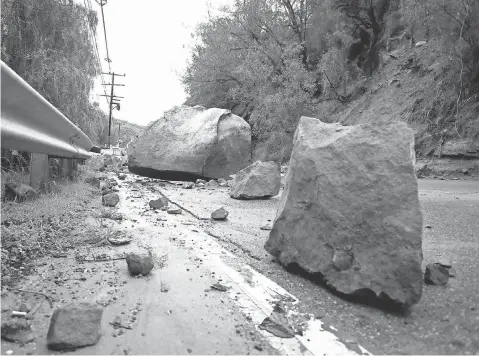  ?? MIKE NELSON, EPA ?? Boulders block Topanga Canyon Boulevard in California Monday after torrential rain unleashed flooding and landslides.