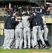  ?? JIM MONE — THE ASSOCIATED PRESS ?? New York Yankees players celebrate after their 5-1victory over the Minnesota Twins in Game 3 of a baseball American League Division Series, Monday in Minneapoli­s.