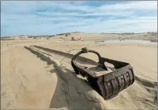  ??  ?? IDLE DREDGING equipment sits on the beach. For decades, Mexico-based Cemex has trucked away sand unchecked.