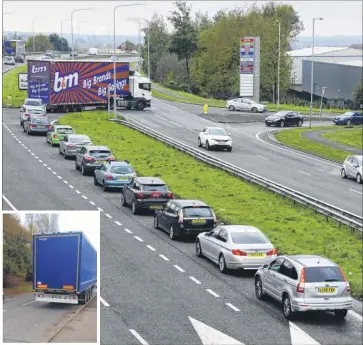  ??  ?? Traffic builds up at the junction, and inset, the lorry trailer