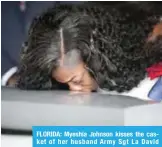  ??  ?? FLORIDA: Myeshia Johnson kisses the casket of her husband Army Sgt La David Johnson during his burial service at the Memorial Gardens East cemetery in Hollywood, Florida.