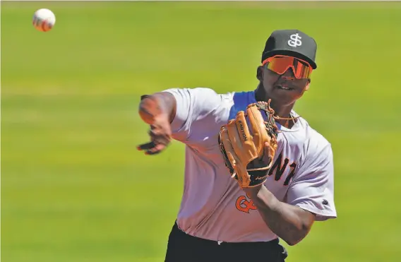  ?? Photos by Carlos Avila Gonzalez / The Chronicle ?? Marco Luciano’s bat speed, athleticis­m and arm strength have many scouts saying he’ll become a shortstop in the mold of Fernando Tatís Jr. or Carlos Correa.