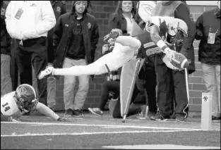  ?? Mary Schwalm The Associated Press ?? Boston College wide receiver Thadd Smith dives into the end zone past North Carolina State safety Dexter Wright on a 12-yard touchdown run in the third quarter of the Wolfpack’s 17-14 win Saturday.