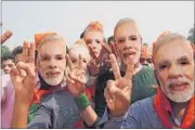  ?? AP PHOTO ?? BJP supporters don Narendra Modi masks to welcome the Prime Minister in Gaya on Monday.