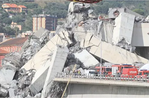  ?? VALERY HACHE/AGENCE FRANCE-PRESSE ?? RESCUERS work at the site where the Morandi motorway bridge collapsed in Genoa two years ago. Italy inaugurate­s a sleek new bridge in Genoa on, though relatives of the 43 people killed when the old viaduct collapsed say the pomp and ceremony risk overshadow­ing the tragedy.