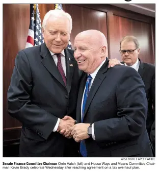  ?? AP/J. SCOTT APPLEWHITE ?? Senate Finance Committee Chairman Orrin Hatch (left) and House Ways and Means Committee Chairman Kevin Brady celebrate Wednesday after reaching agreement on a tax overhaul plan.