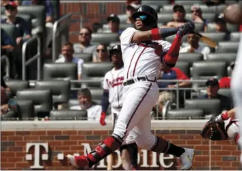  ??  ?? Atlanta Braves center fielder Ronald Acuña Jr. (13) follows through on a solo home run in the third inning of a baseball game against the Philadelph­ia Phillies on Thursday, in Atlanta. AP PHOTO/JOHN BAZEMORE