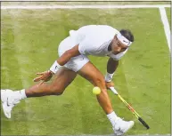  ?? Glyn Kirk / AFP / Getty Images ?? Spain’s Rafael Nadal returns against US player Sam Querrey during their men’s singles quarterfin­al match at Wimbledon on Wednesday.