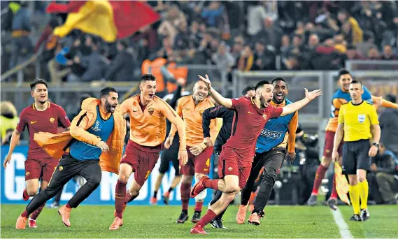  ??  ?? Shock winner: Kostas Manolas sparks wild celebratio­ns after scoring Roma’s third goal to send Barcelona crashing out of the tournament