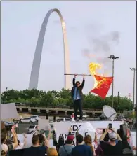  ?? (Photo courtesy of Madeline Houston via The New York Times) ?? Peter McIndoe burns a St. Louis Cardinals flag in St. Louis in July during a satirical protest of the baseball team’s logo. The Birds Aren’t Real movement has become “an experiment in misinforma­tion,” McIndoe said. “We were able to construct an entirely fictional world that was reported on as fact by local media and questioned by members of the public.”