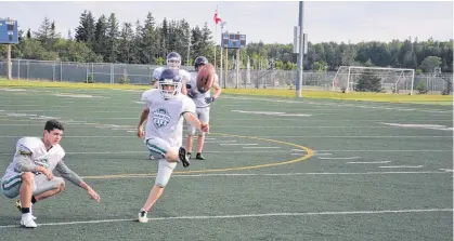  ?? JASON SIMMONDS • THE GUARDIAN ?? Place-kicker Yannick MacPhee of Charlottet­own practises field goals at the Terry Fox Sports Complex in Cornwall on July 14. Zackary Blood is the holder. MacPhee will play his first-ever tackle football game with Team P.E.I.’s under-18 club at the Atlantic Bowl in Antigonish, N.S., on July 21.