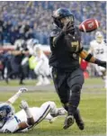  ?? AP PHOTO/MATT SLOCUM ?? Army’s Jaylon McClinton bats a pass intended for Navy’s Mychal Cooper during the first half Saturday in Philadelph­ia. Army beat Navy 17-10.