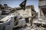  ??  ?? Soldiers in Mosul examine an unused Islamic State car bomb in July. The city is trying to asborb residentia­l returns a year after the terrorist group was ousted, and does not have the personnel to clear ordnance.