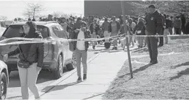  ?? ULYSSES MUÑOZ/BALTIMORE SUN ?? Students at Frederick Douglass High School were evacuated after a 56-year-old staffer was shot inside Friday afternoon.