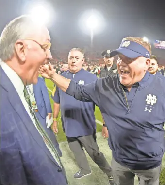  ?? KIRBY LEE/USA TODAY SPORTS ?? Athletics director Jack Swarbrick and head coach Brian Kelly celebrate the victory against Southern California that completed Notre Dame’s 12-0 regular season.