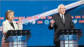  ?? JUSTIN SULLIVAN/GETTY ?? Democratic hopefuls Hillary Clinton and Bernie Sanders split widely over gun policies.