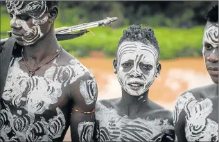  ??  ?? SYMBOLS AND SIGNS: Youths from the Karo tribe in their village near the Omo River