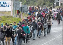  ?? Moises Castillo The Associated Press ?? Honduran migrants walk Wednesday along the roadside through Esquipulas, Guatemala, as they make their way toward the U.S. border.