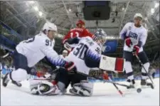  ?? BRUCE BENNETT — THE ASSOCIATED PRESS ?? Matt Gilroy (97), goalie Ryan Zapolski (30) and Jordan Greenway (18), of the United States, reach for the puck during the first period of the preliminar­y round of the men’s hockey game against the team from Russia at the 2018 Winter Olympics in...