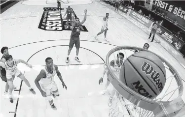  ?? Tim Nwachukwu / Getty Images ?? Abilene Christian’s Joe Pleasant hits the game-winning free throw against Texas in the first round of the NCAA Tournament on Saturday night. Pleasant finished with 11 points, including two final foul shots.