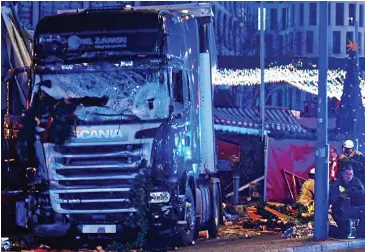  ??  ?? Horror: The lorry that ploughed through a Berlin Christmas market last year, killing 12