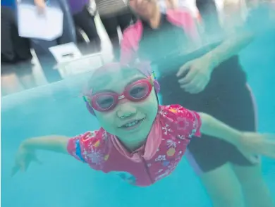  ?? PHOTO: PATIPAT JANTHONG ?? BABY BLUE A girl dives to retrieve an item as part of the activities at a sports day, which features a water competitio­n for children aged between 18 months and seven years. The event was held at the Bang Na branch of the Baby Pool Swimming Centre...