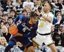  ?? Mark Stockwell/Associated Press ?? UConn’s Stephon Castle (5) looks to drive against Providence’s Rafael Castro during the first half on Saturday.