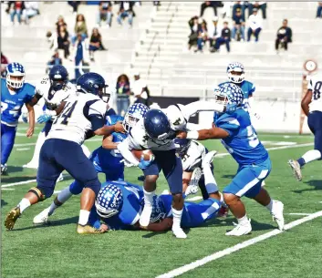  ?? PHOTO AARON BODUS ?? Central’s Zachary Morquecho (center-right) snags Morse running back Shamar Martin, early in the first quarter of Saturday’s CIF-SDS Division III championsh­ip game at Southweste­rn College in Chula Vista.