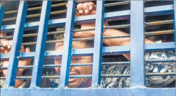  ?? AFP ?? A suspect inside a vehicle reacts following a verdict that sentenced 16 people to death over the murder of 19-year-old Nusrat Jahan Rafi, in Feni, Bangladesh on Thursday.