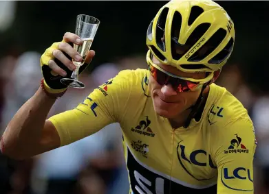  ?? Photograph: AP ?? Chris Froome celebrates winning the Tour de France for a third time in 2016