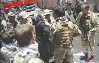  ?? AP PHOTO ?? A woman tries to stop police from firing on protesters during a demonstrat­ion in Kabul, Afghanista­n.