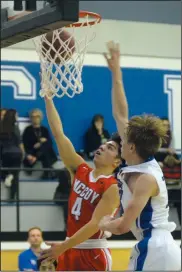  ?? NEWS PHOTO SEAN ROONEY ?? Monsignor McCoy guard Ethan Gripp (4) goes in for a layup past Crescent Heights centre Chris Gilham during a varsity boys basketball game Wednesday at Crescent Heights.