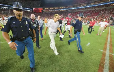  ?? KEVIN C. COX/GETTY ?? Alabama coach Nick Saban walks off the field Saturday night after losing to Texas 34-24 in Tuscaloosa, Alabama.
COLLEGE FOOTBALL