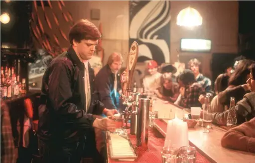  ??  ?? Zay N. Smith, aka Norty the bartender, behind the bar at the Mirage, the bar that the Chicago Sun-Times bought and operated to document graft in Chicago.