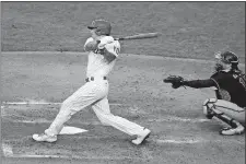  ?? MATT SLOCUM/AP PHOTO ?? In this Aug. 10, 2020, file photo, Philadelph­ia Phillies catcher J.T. Realmuto follows through after hitting a two-run home run off Atlanta Braves pitcher Robbie Erlin during a game in Philadelph­ia.