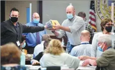  ?? AIMEE DILGER / SOPA IMAGES VIA SIPA USA ?? Employees open mail-in ballots to be counted for the US presidenti­al election at an elections board in Luzerne county, Pennsylvan­ia, on Wednesday.