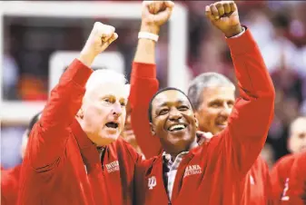  ?? Justin Casterline / Getty Images ?? Former Indiana head coach Bob Knight and former Hoosiers player Isiah Thomas lead the crowd in cheers during a halftime ceremony. Knight was fired by Indiana in 2000.