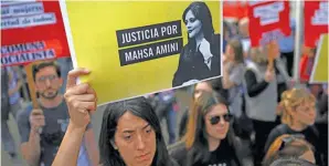  ?? AFP/LUIS ROBAYO ?? An activist holds a sign reading: ‘Justice for Mahsa Amini’ during a protest over her death in Iran, outside the Iranian Embassy in Buenos Aires last Tuesday.