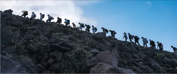  ?? PHOTOS: VOLCANO ADVENTURES ?? Hikers make their way up the volcano on Italy’s Stromboli island. It’s one of the 1,500 potentiall­y active volcanoes in the world.